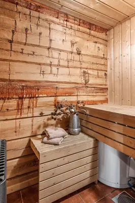 a sauna with a tea kettle on a wooden wall at Trysilfjellet Nord 356 A and B in Trysil