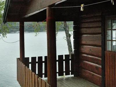 an outside of a cabin with a body of water at 4 person holiday home in Surna in Glerem