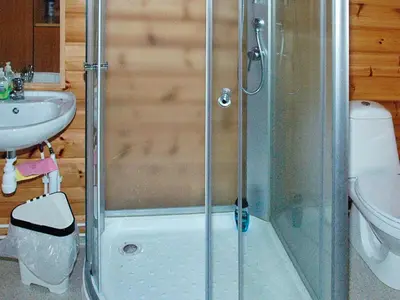 a shower with a glass door in a bathroom at 5 person holiday home in VÅGLAND in Bårdset