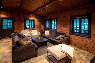 a living room with couches and tables and windows at Trysilfjellet Nord 170 in Trysil