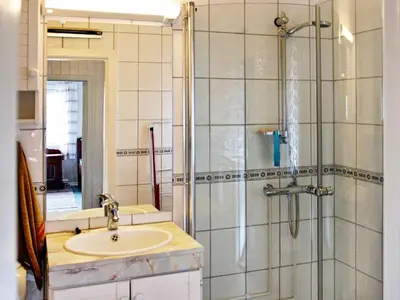 a bathroom with a sink and a glass shower at 6 person holiday home in Otta in Otta