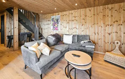 a living room with a couch and a table at Cozy Home In Rauland With Sauna in Rauland