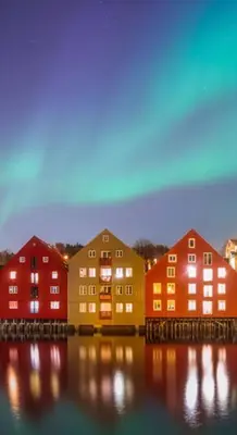 a group of colorful buildings sitting on the water at Unik og koselig leilighet midt i sentrum av Trondheim in Trondheim