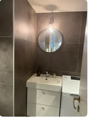 a bathroom with a sink and a mirror at Unik og koselig leilighet midt i sentrum av Trondheim in Trondheim