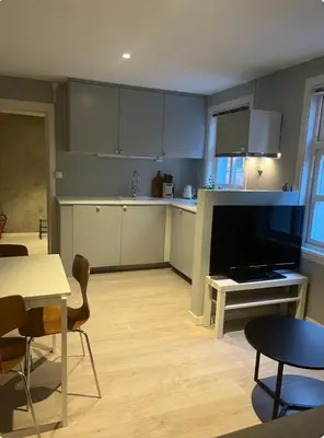 a kitchen with a table and a dining room at Unik og koselig leilighet midt i sentrum av Trondheim in Trondheim