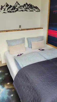 a bedroom with two beds with blue pillows at Apartment Fjordblick in Leikanger