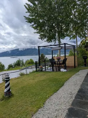 a garden with a table and a gazebo at Apartment Fjordblick in Leikanger