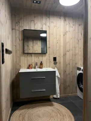 a bathroom with a sink and a washing machine at Ny koselig hytte ved Sogn skisenter in Hafslo