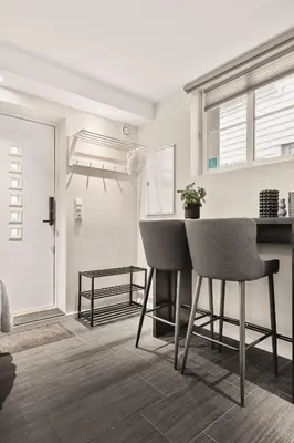 a living room with two chairs and a table at 500 m til Bryggen I Skjermet Uteplass! in Bergen