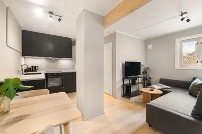 a living room with a couch and a table at Central and modern apartment in Trondheim