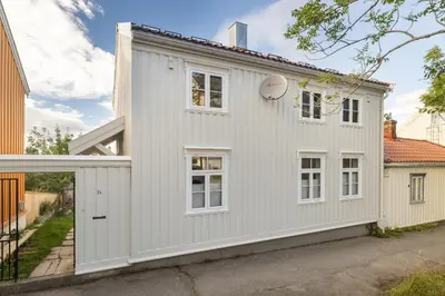a house with a white exterior at Central and modern apartment in Trondheim