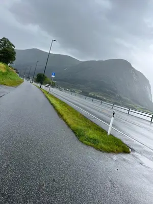 an empty road with a street light on the side of the road at Husslåttene apartments with terrace in Skei