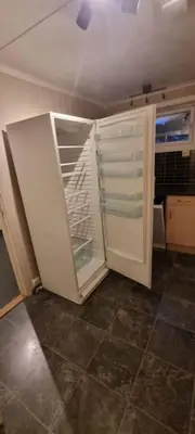 a white refrigerator in a kitchen with its door open at Sokkel-leilighet med nærhet til sentrum og Hovden skiheis in Oppdal