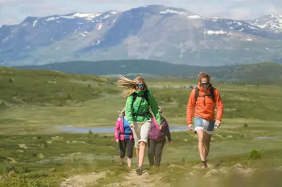 a group of three people walking down a trail at Storefjell Resort - Panorama apartments in Gol