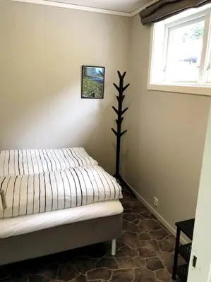 a bedroom with a bed and a window in it at Flat in the center of Loen in Loen