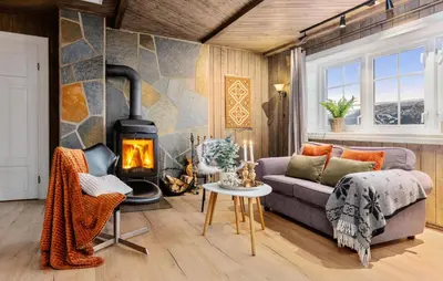 a living room with a couch and a fireplace at Awesome Home In Svingvoll With Sauna in Svingvoll
