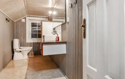 a bathroom with a toilet and a sink at Awesome Home In Svingvoll With Sauna in Svingvoll