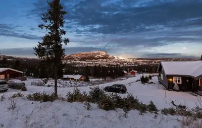 a car parked in the snow next to a house at Awesome Home In Svingvoll With Sauna in Svingvoll