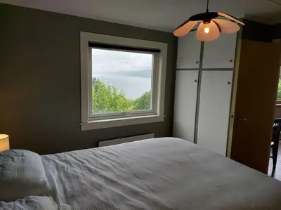 a bedroom with a bed and a window at Norwegian Fjords Time Out in Stranda