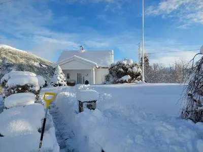 a house covered in snow with a parking meter at Norwegian Fjords Time Out in Stranda