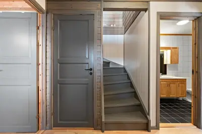 a hallway with a door and stairs in a kitchen at Spacious cabin with a fabulous view and a sauna in Skulestadmo