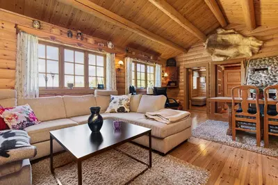 a living room with a couch and a table at Charming cabin retreat by the coast in Midsund in Midsund