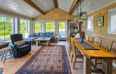 a living room with a couch and a table at Nice Home In Vinje With House Sea View in Trovatn