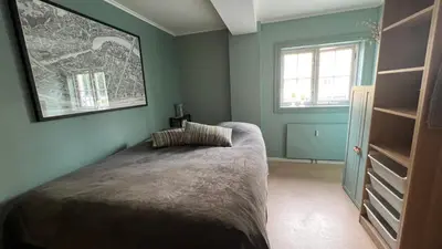 a bedroom with a bed and a window at Rustic Apartment in Bakklandet in Trondheim