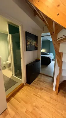 a bedroom with a bed and a large mirror at Rustic Apartment in Bakklandet in Trondheim