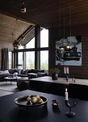 a living room with a couch and a table at New chalet with great view in Hafjell
