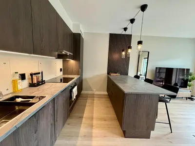 a large kitchen with a counter and a table at Luxury Apartment in Bergen, 10min from City Centre in Bergen