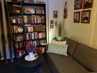 a living room with a couch and a table at Hessahuset in Ålesund