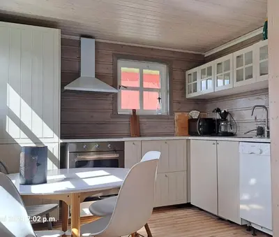 a kitchen with a table and chairs in a room at Kårhus på småbruk in Lia