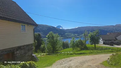 a house with a view of a lake and mountains at Kårhus på småbruk in Lia