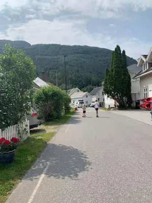 a man and a child walking down a street at Feriehus ved fjorden i Solvorn in Luster
