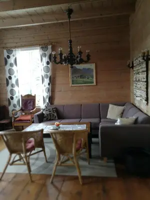 a living room with a couch and a table at Dønhaug Gjestegard in Uskedalen
