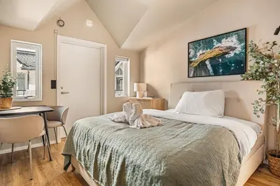 a bedroom with a bed and a table and a desk at Dinbnb Apartments I Explore Bergen! I 650m To Bryggen I Easy Check-in in Bergen