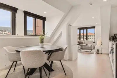 a dining room with a table and chairs at Dinbnb Apartments I Penthouse 250m From City Center I Privat Balcony in Bergen