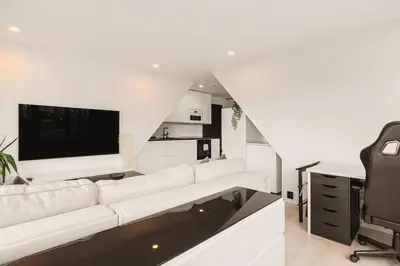 a living room with a white couch and a tv at Dinbnb Apartments I Penthouse 250m From City Center I Privat Balcony in Bergen