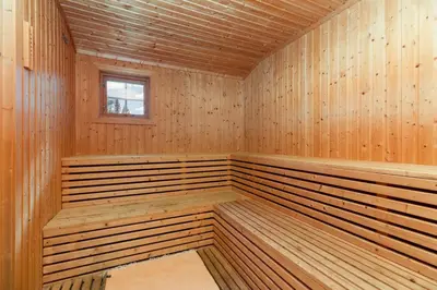 a sauna with wooden walls and a window at Frøy&Frøya Hyttetun in Skammestein