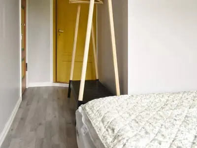 a bedroom with a bed and a yellow door at 9 person holiday home in Åram in Sandvik