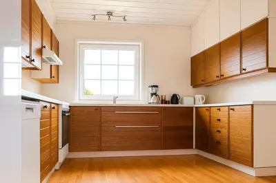 a kitchen with wooden cabinets and a window at Hus med panoramutsikt i Bud in Bud
