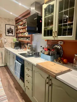 a kitchen with white cabinets and a counter top at Vintage apartment with fresh sea air and pets in Kristiansund