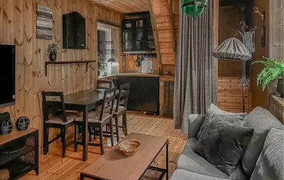 a living room with a table and a kitchen at 3 Bedroom Amazing Home In Tysse in Tysse