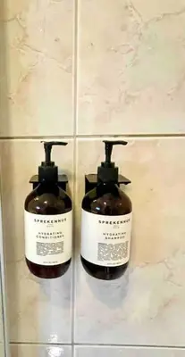 two bottles of soap on the wall of a bathroom at Et helt hus i fredelige omgivelser med utsikt! ca 10 min fra Trondheim sentrum in Trondheim