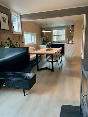 a living room with a table and a dining room at Et helt hus i fredelige omgivelser med utsikt! ca 10 min fra Trondheim sentrum in Trondheim