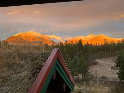 a tent in a field with mountains in the background at Rondane - Øvre Nordli Sollia Friluftsliv in Atnfoss