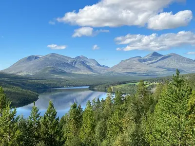a view of a lake with mountains in the background at Rondane - Øvre Nordli Sollia Friluftsliv in Atnfoss
