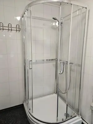 a shower with a glass enclosure in a bathroom at Leilighet Vingnes in Lillehammer