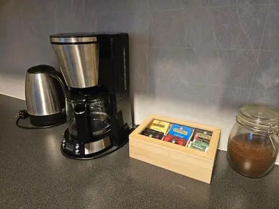 a coffee maker sitting on a counter next to a box at Leilighet Vingnes in Lillehammer
